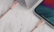Pink lightning charging cable plugged into a tablet