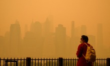A person wears a face mask as smoke from wildfires in Canada cause hazy conditions in New York City