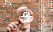 Man holding magnifying glass with digital illustration inside it