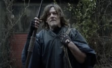 Norman Reedus as Daryl from "The Walking Dead" in a poncho holding a spear.