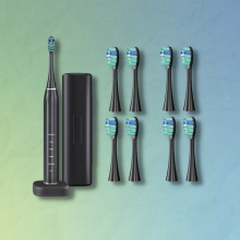 electric toothbrush with extra brush heads and blue and green gradient background