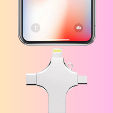 The 4-in-1 Smart Flash Drive near an iPhone overlaid on a colorful pink-and-yellow gradient background